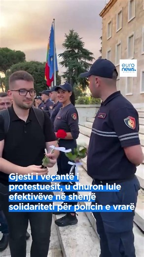 Protester's special gesture, gifts flowers to officers in a sign of solidarity for the killed pol...