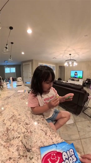 After Checking the Flavors, Chloe Happily Chose the Watermelon Airheads.