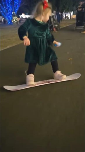 baby doing ski on concrete