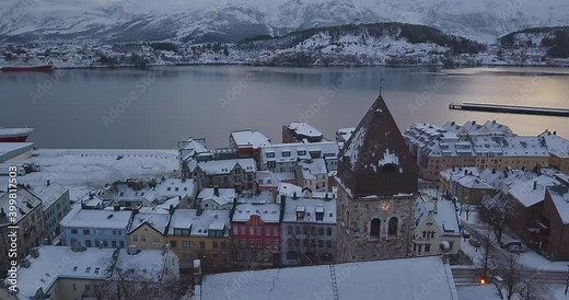Cinematic aerial drone footage of downtown Alesund, Norway's most beautiful town in winter when everything is covered in snow. We are flying over the church and other remarkable art nouveau buildings. Stock Video