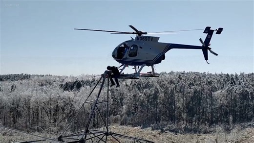 Helicopter crew inspects power lines after deadly US storm
