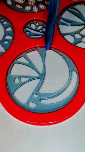 the creative process of making Spirograph art! 🎨 The person's hand is using a purple tool to add intricate details to the design, which is taking shape on the red plastic surface. The concentric circles with different colors and patterns are starting to come together, creating a mesmerizing effect. It's great to see the artistic process in action! #artisticexpressionvideo #spirographobsessed #foryoupage #circularmagic #spirographaddict #satisfying #50MillionViews | Spirographshr