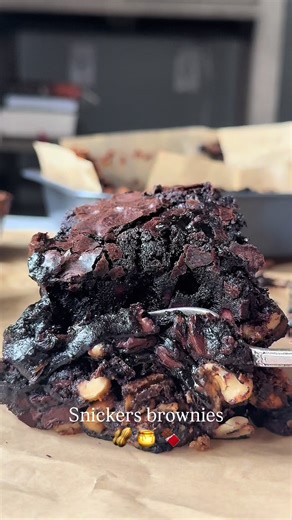 Comment RECIPE for the full recipe! These Snickers Brownies are perfect for all you chocolate peanut butter lovers! The brownies are fudgy and gooey and stuffed with a layer of caramel, peanut butter, peanuts. They are ultra gooey with a little added crunch. The dark chocolate and peanut butter combination is classic and irresistible. These brownies are a step above your average brownies – the gooey caramel peanut butter filling makes them instantly incredible! #snickersbrownie #peanutbutterbrow