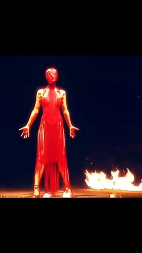 The iconic Alexander McQueen Fall/Winter 1998 "Joan" collection, heavily inspired by Joan of Arc, featured a finale with model Erin O'Connor wearing a red beaded dress and face mask, swaying in a ring of fire. #iconic #McQueen #legend #fyp #fashion #styleblogger #fashionweek #fashionblogger #fashiondesigner #fashionblog #fashionmodel #fashionista #Runway #catwalk #collection #fashionblog #blog #fashionaddict #fashionstyle | Style Revolver