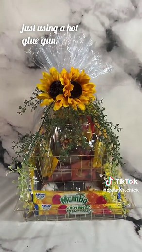 DIY Sunshine & Snacks Gift Basket Tutorial! ☀️🌻 Creative Chick LLC specializes in custom gift baskets for any occasion and this one was so fun to make! This basket was for someone who loves savory snacks and sunflowers, so the basket was themed around candy and snacks with a few sunflower themed items added in. Check out www.creativechick.store for more fabulous gifts and while you’re there check out our wreaths too! Make sure to let us know in the comments what tutorials you would like to see
