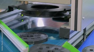 Close up: automated sorting systems with cameras and lighting for inspecting workpieces and controlling components on conveyor belt. Inspection, sorting, measuring and quality control concept