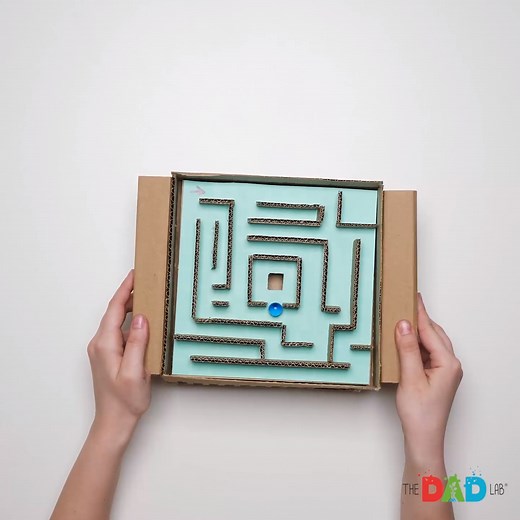 Tilt the board to move the marble! Can you make it through the labyrinth? Here is how to make your own marble maze game. Make as many different boards and mazes as you like, for hours of fun! ⭕ Materials: - Cardboard - Hot glue gun & glue - Ruler - Pencil - Tape - Coloured card - Pen - Marble ⭕ Instructions: (1) To make your board, start with a square piece of cardboard and glue boarders around each edge. (2) Next, glue 3 small pieces of cardboard together and secure them to the board. Repeat th