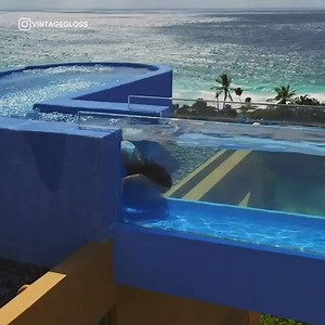The see-through bridge connects two larger pools | In The Know Travel