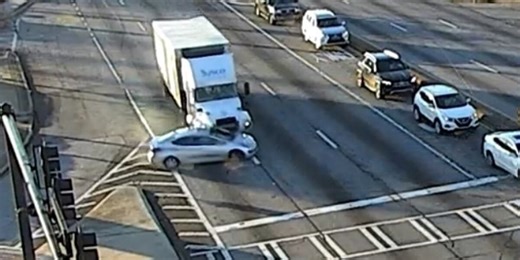 Truck driver pushes car through 2 intersections before driving off, video shows