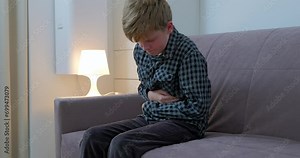 Little boy suffering from stomachache at home.The child has a stomach ache.