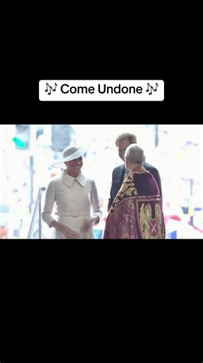 Fixes her mic at the bottom of the stairs…walks up… fixes it AGAIN