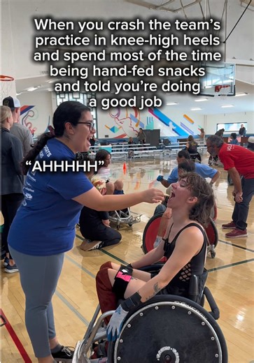 Full face of makeup, knee-high heels and a lace up body suit. Yup.. perfect for crashing the team practice 😎🤘🏼 Murder-ball (wheelchair rugby) highlights coming soon! 🤭✨ Alt text: the screen says “When you crash the team’s practice in knee-high heels and spend most of the time being hand-fed snacks and told you’re doing a good job” over a video of a woman being hand-fed an apple slice by another woman. Captions are on screen for accessibility. #Rugby #Wheelchair #MurderBall #TeamPractice #Cra