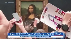 Man throws cake at Mona Lisa painting