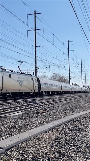 Amtrak Acela Westbound Acela train meets Eastbound Pennsylvanian train In Morrisville