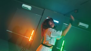 Energetic dance in neon-lit room