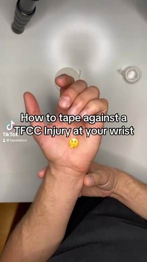 How to tape against a TFCC Injury at your wrist 🤔 Steps: 1. Roll a strip inside out to get a tube 2. Place the sticky tube where the ulna bone meets the wrist bone 3. Wrap around your wrist once to lock the tube in place 4. Use another strip to add tension for more pressure on the TFCC What is a TFCC Injury ⁉️ A TFCC (Triangular Fibrocartilage Complex) injury in the wrist occurs when the cartilage and ligaments that stabilize the small bones in the wrist are damaged. This injury is often caused