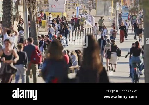 crowds on barcelona beach in la barceloneta neighborhood in spring