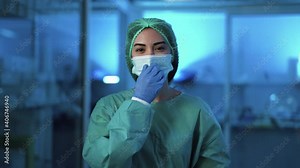 Female doctor move surgical face mask and smiling - Health care worker inside hospital