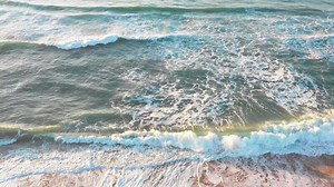 an aerial view of the ocean waves