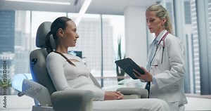 Female Doctor Consults With Female Patient in a Futuristic Medical Lab, Discussing Innovative Healthcare Solutions. the High-tech Clinic Features Advanced Technology and Modern Design Elements.