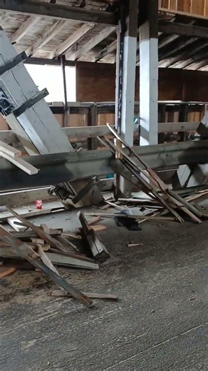 Old Boards piled inside Hartland,NB Covered Bridge from being taken off Sidewalk.Renovations .