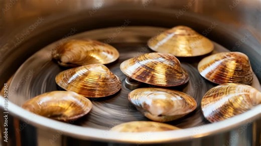 Mottled effect sugar shells being refined in a finishing tumbler showcasing the unique variegated patterns gaining depth and shine with each rotation.