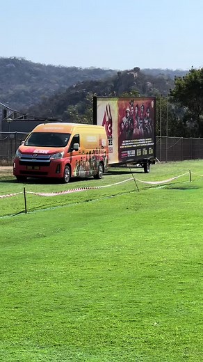 Summer Blaze: Vibrant Van in Scenic Open Field
