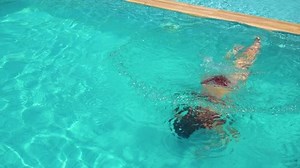 clip-1020388843-woman-swimming-under-water-pool