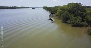 Sunken old ship in Brazilian River, Aerial zoom pan inspecting the rusted shipwreck