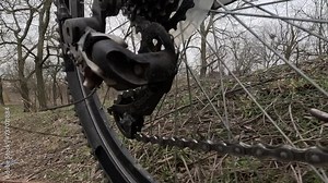 Bicycle drivetrain system chain rotating, close-up. Gear system bike wheel. Cycling crankset bike wheel