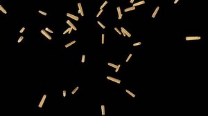 Empty bullet shells falling after shooting slow motion, black background
