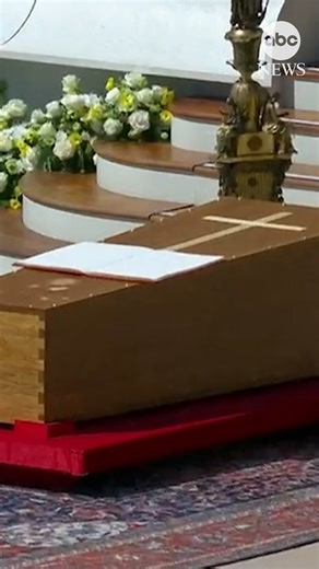 The simple, wooden casket of Pope Francis lies in St. Peter's Square as hundreds of thousands observe a moment of silence during his funeral. It was a reflection of Francis' 12-year papacy to stress priests as servants and to construct "a poor church for the poor." As part of Francis’ push to simplify the papal funeral rites, his body is in a single wooden coffin. https://abcnews.link/QlKgMHq | ABC News
