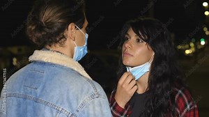 love in time of covid - woman pulls down her boyfriend's mask and kisses him