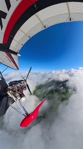 Airborne Trike Gliding 5,000 Feet Above Clouds