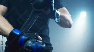 Man holds pair of boxing gloves. Boxer wearing gloves before fighting. Fighter feeling weight and presence of sport. He exudes confidence and readiness for challenge ahead. Close-up in 4K, UHD