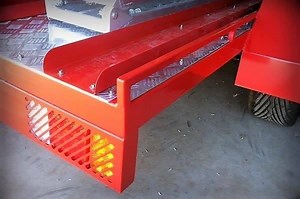 Michael built a sporty looking motorbike trailer with enough jerry can holders to keep three bikes running for the weekend. The front cross member has been extended to improve tie-downs (yes, love it). The mag wheels, alloy chequer plate and brilliant paint finish really sets this trailer off. | Trailer Plans