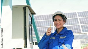 Female electrician inspecting solar panel control panel using electric screwdriver check current for safety : Portrait female engineer working in the field solar panel installation station outdoors.