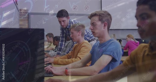 Instructor moving lab row, leaning over student, pointing at monitor, students typing for help