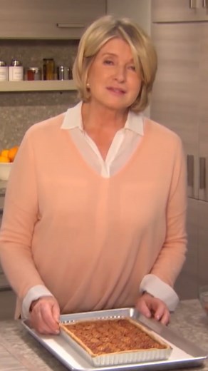 Martha's unique take on traditional pecan pie features halved pecans in diagonal lines atop a rectangular tart for a dramatic look. A filling that features even more pecans uses lemon zest to balance out the sweetness of the nut. Get the recipe: bit.ly/40jru7z | Martha Stewart