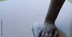 Woman cleaning table surface with wet wipes and antiseptic liquid
