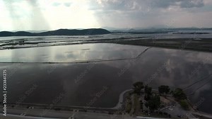 Alykes the Hellenic saltworks located outside of Mesolongi in Greece. Drone footage with the clouds reflection in the salt water.