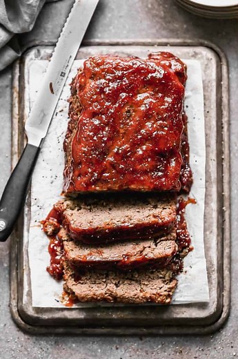 Gather around the table for some comforting MEATLOAF topped with the most delicious sauce (with a top-secret ingredient!). Serve this heartwarming dinner with mashed potatoes and a veggie for a perfect weeknight meal. https://tastesbetterfromscratch.com/meatloaf/ | Tastes Better From Scratch