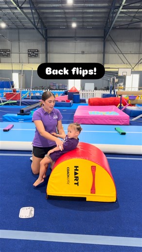 Gymnastics By JUST on Instagram: "Coach mode: ON. Tiny assistant: absolutely nailing their role. Backflips don’t just happen — they’re broken down step by step, with safe holds, clear cues, and a very willing Kindergym “demo partner” 🌀 Learning the right way, from the very beginning (with a side of cuteness). #GymnasticsByJust #KinderGym #CoachLife #SkillBreakdown #TinyGymHelper"