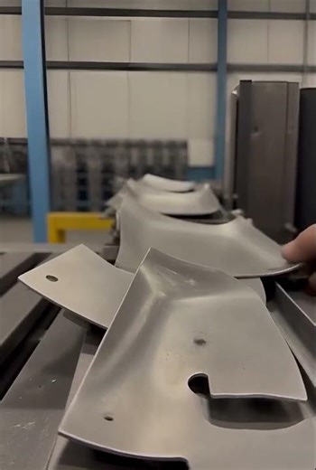 Automated system stacking unused metal scraps after welding, metal drop sound.