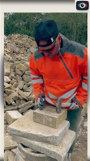 Watch as a man skillfully breaks a solid rock using just a hammer and a flat steel chisel!