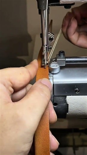 Stitching leather strap carefully using sewing machine