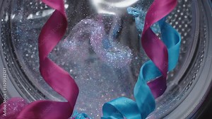 Extreme slow motion abstract visualization inside a washing machine drum showing shimmering cleaning particles mixing with water and gently flowing stylized fabric shapes texture, product, efficiency