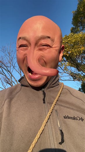 Bald Man Enjoys Morning Sun While Stretching Nose