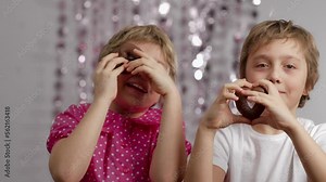 Gingerbread in the shape of hearts in the hands of girl and boy.