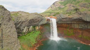 Waterfall of Agrio river, Patagonia, Neuquen in the provincial Park of Copahue with rocks that turned red through corrasion due to volcanic activities.